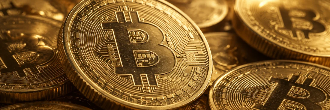 Illustrative close-up of gold Bitcoin coins